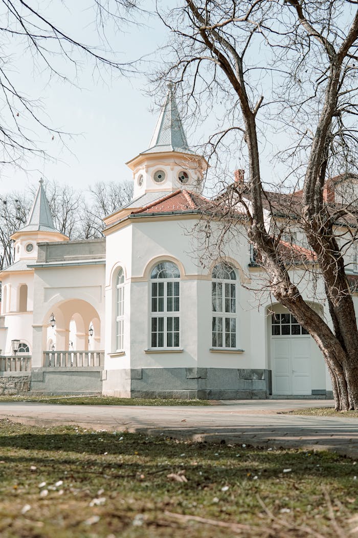 Charming historic building with unique architecture and tower, surrounded by serene nature.