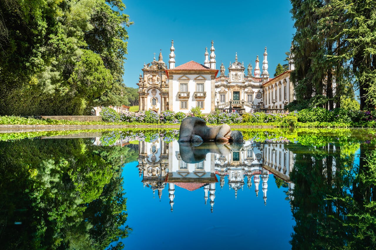 Beautiful summer day at the Palace of Mateus, Vila Real, Portugal, with a serene reflective pond.